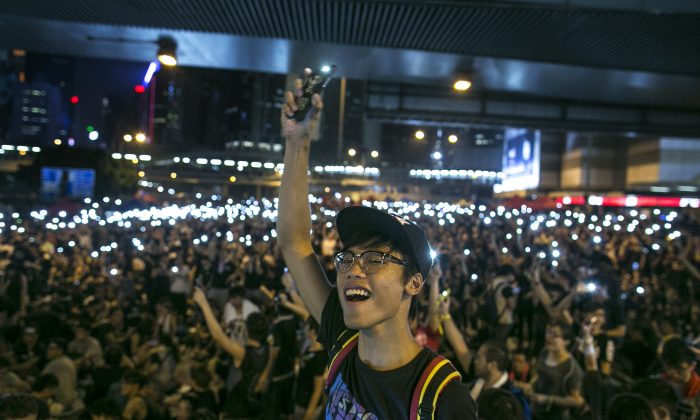 Protesters shine lights from their cell phones as they chant pro-democracy slogans on the streets of Hong Kong on Sept. 30, 2014. The United States and Canada issued statements supporting Hong Kong's pro-democracy movement. (Paula Bronstein/Getty Images)