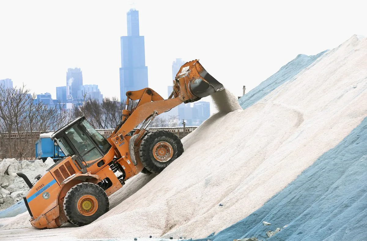 A Streets and Sanitation worker grooms a pile of road salt as the city makes preparations for another winter storm in Chicago, Illinois, Feb. 4, 2014. (Scott Olson/Getty Images)