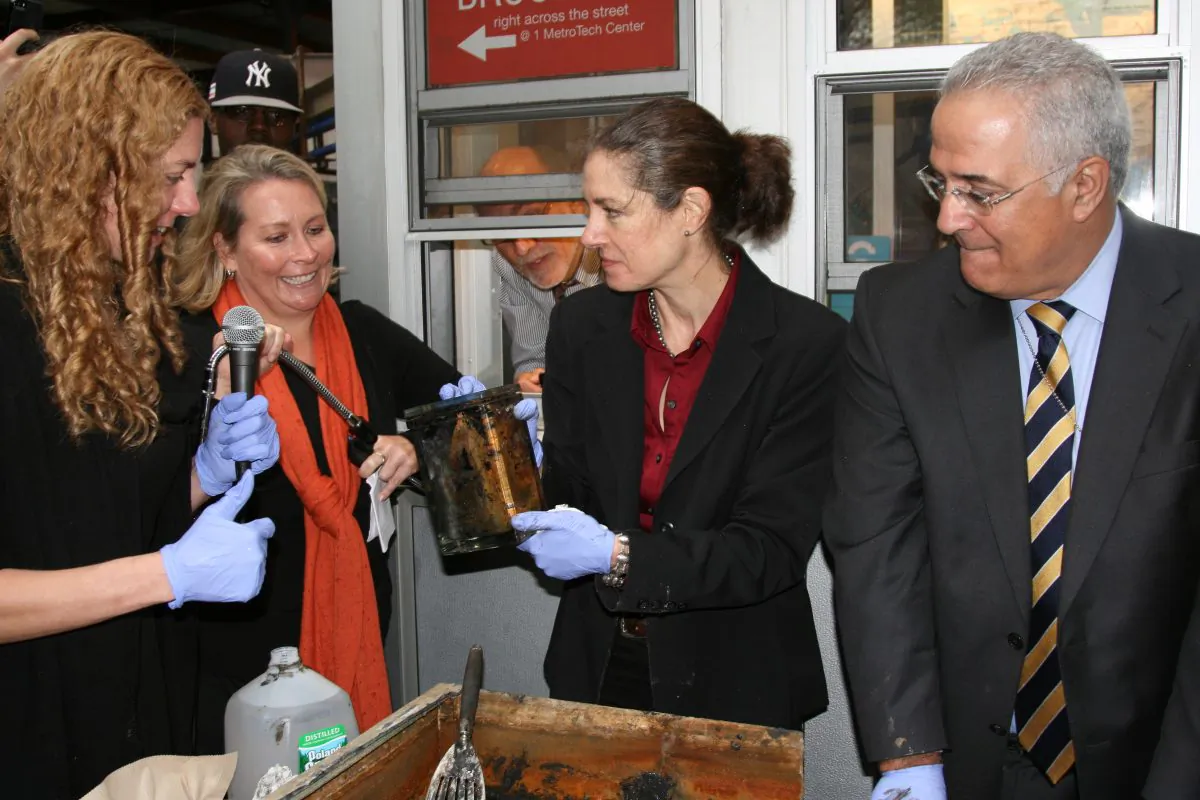 Conservator Toya Dubin (C) presents the glass canister in Brooklyn, N.Y., on Oct. 1, 2014. (Shannon Liao/Epoch Times)