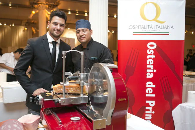 Massimiliano Cortese (L), manager at Osteria del Principe with a staff member at Ospitalità Italiana. The event, held at the Metropolitan Pavillion on Sept. 23, showcased authentic Italian cuisine. (Samira Bouaou/Epoch Times)
