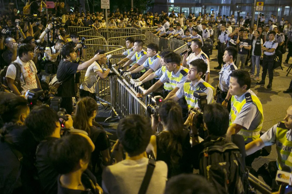 Protesters confront police overnight outside the legislative government complex on October 2, 2014 in Hong Kong. Thousands of pro democracy supporters continue to occupy the streets surrounding Hong Kong's financial district. The protests are a new geopolitical threat affecting financial market sentiment. (Paula Bronstein/Getty Images)