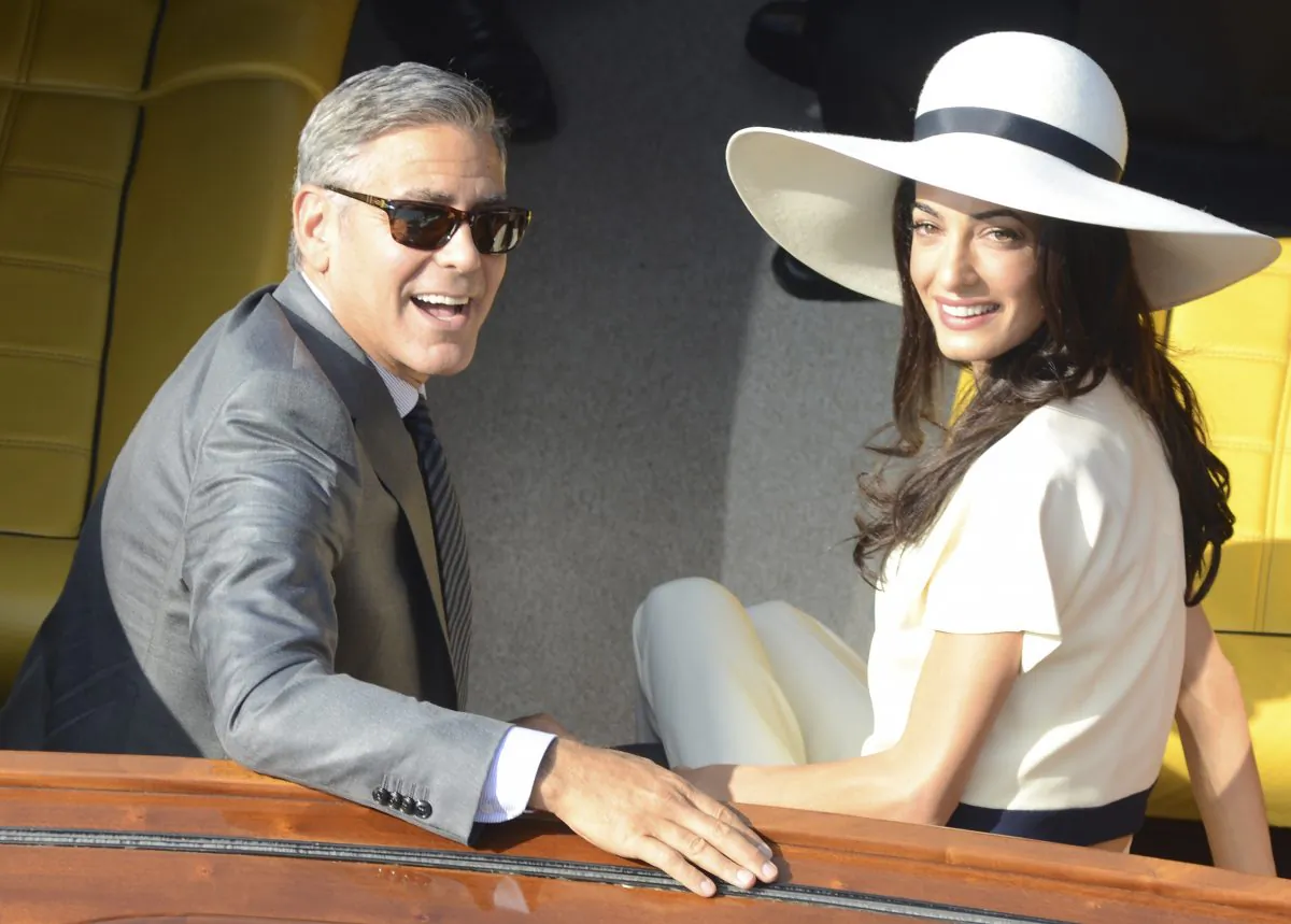 George Clooney and his wife Amal Alamuddin leave the city hall after their civil marriage ceremony in Venice, Italy on Sept. 29, 2014. (AP Photo/Luigi Costantini)