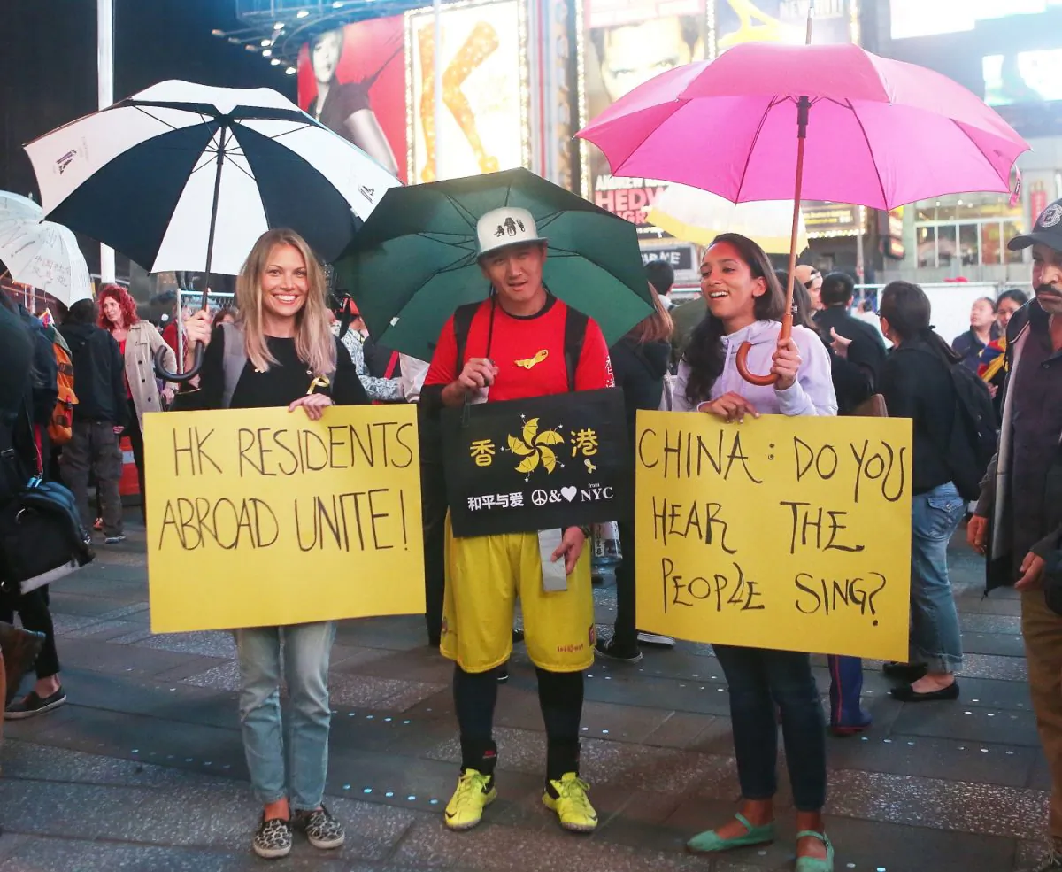 Supporters of Hong Kong's democracy protests gather in Times Square, New York City, on Oct. 1, 2014. The rally was part of a global effort to express solidarity for Hong Kong protestors who have called for universal suffrage by occupying the city's main thoroughfares. (Gary Du/Epoch Times)