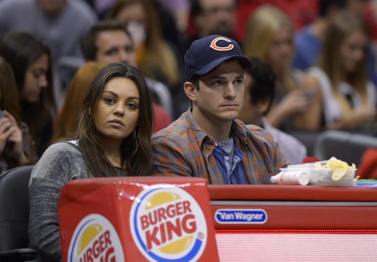 Actors Mila Kunis, left, and Ashton Kutcher watch the Los Angeles Clippers play the Detroit Pistons during the second half of an NBA basketball game, Saturday, March 22, 2014, in Los Angeles. (AP Photo/Mark J. Terrill)