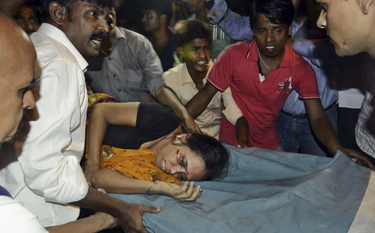 An Injured woman is carried on a stretcher to a hospital for treatment in Patna, India, Friday, Oct. 3, 2014. (AP Photo/Aftab Alam Siddiqui)