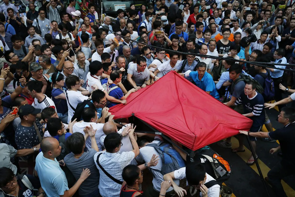 Residents and pro-Beijing supporters tear down a pro-democracy activist tent in Kowloon's crowded Mong Kok district, Friday, Oct. 3, 2014 in Hong Kong. (AP Photo/Wong Maye-E)