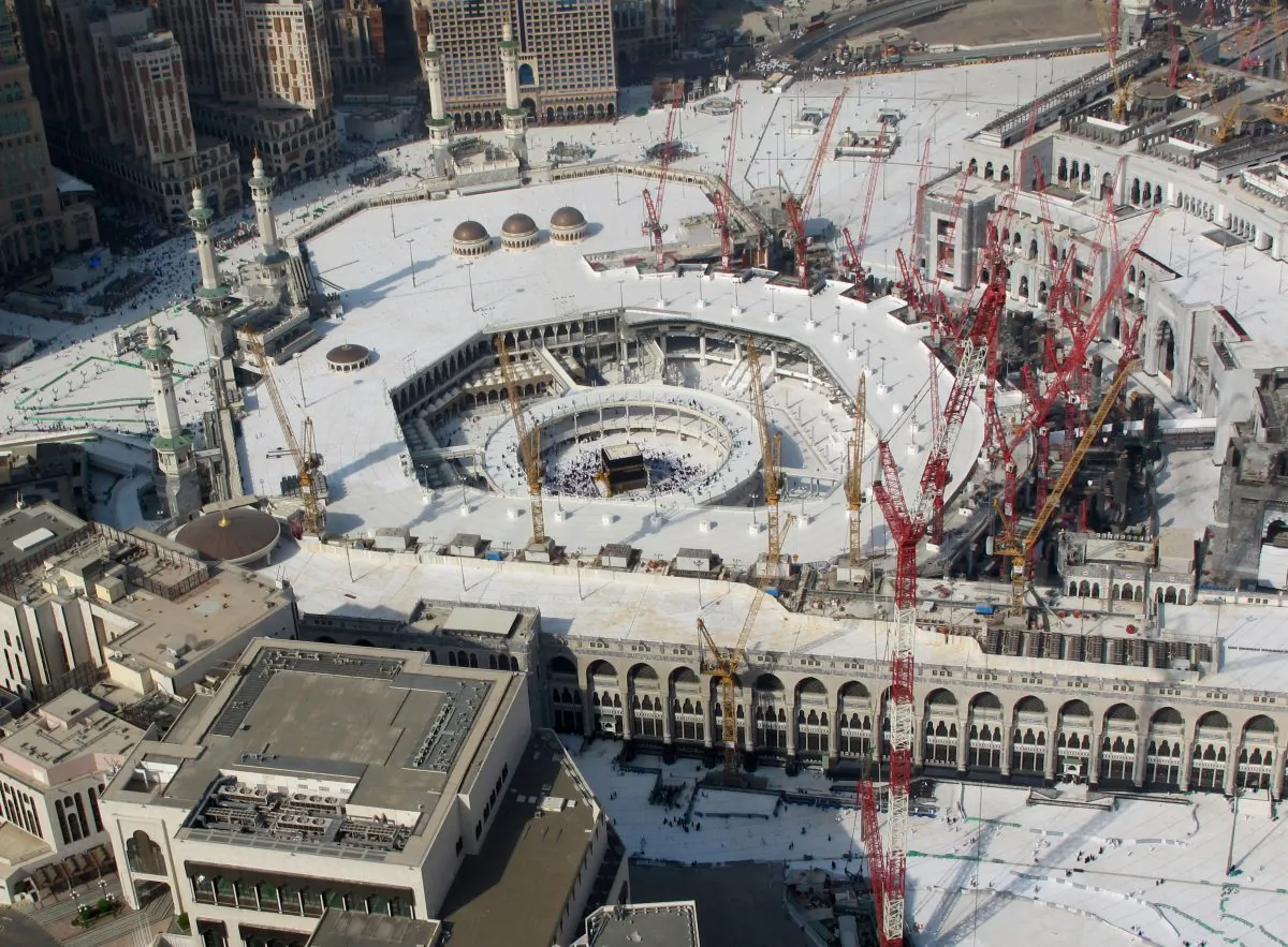 This aerial image made from a helicopter shows Muslim pilgrims circling the the Kaaba in the Grand Mosque in the Muslim holy city of Mecca, Saudi Arabia, during the annual pilgrimage, known as the hajj, near Mecca, Saudi Arabia, Friday, Oct. 3, 2014. (AP Photo/Benjamin Wiacek)