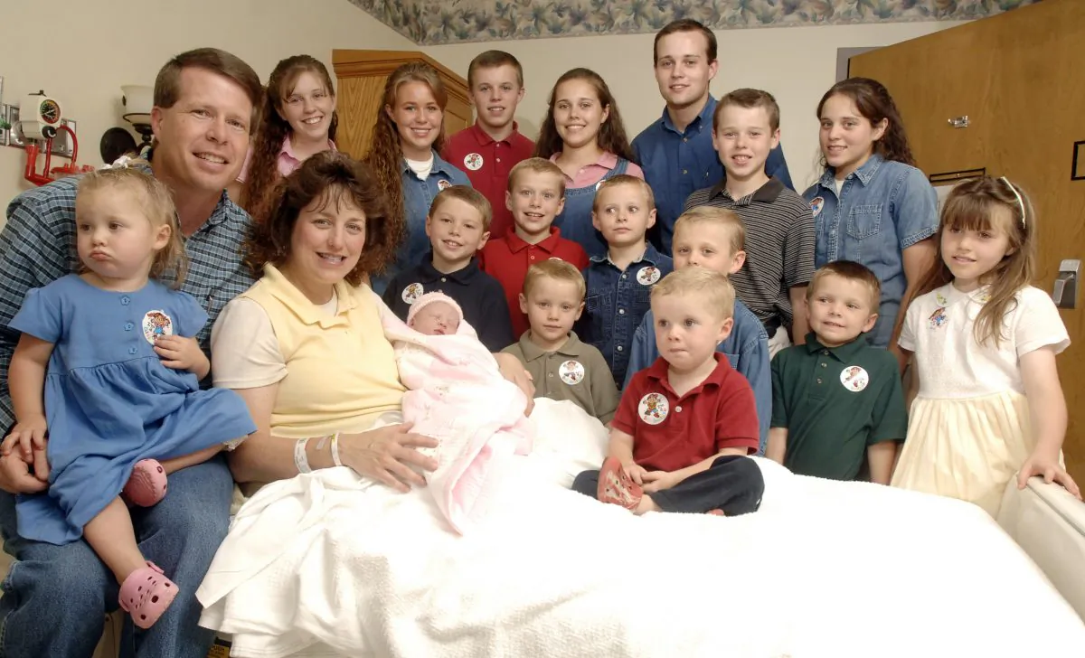 Michelle Duggar, left, is surrounded by her children and husband Jim Bob, third from right after the birth of her 17th child in Rogers, Ark. on Aug. 2, 2007. (Beth Hall/AP Photo)