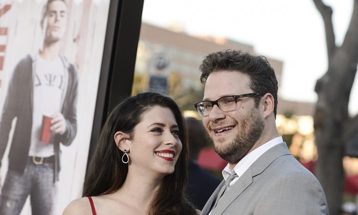 Actor Seth Rogen, right, and his wife Lauren Miller attend the premiere of the feature film "Neighbors" on Monday, April 28, 2014 in Los Angeles. (Photo by Dan Steinberg/Invision/AP Images)