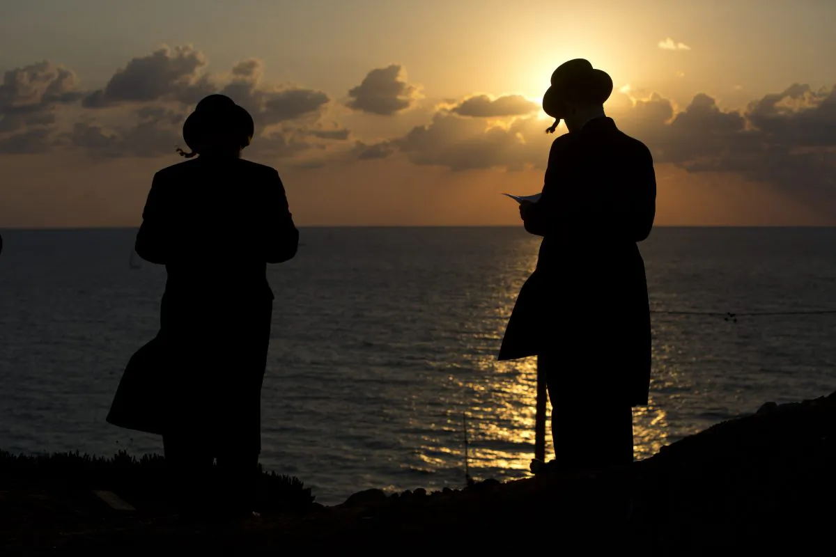 Ultra-Orthodox Jews of the Hassidic sect Vizhnitz gather on a hill overlooking the Mediterranean sea in Herzeliya, Israel, on Oct. 2, 2014. (AP Photo/Oded Balilty)