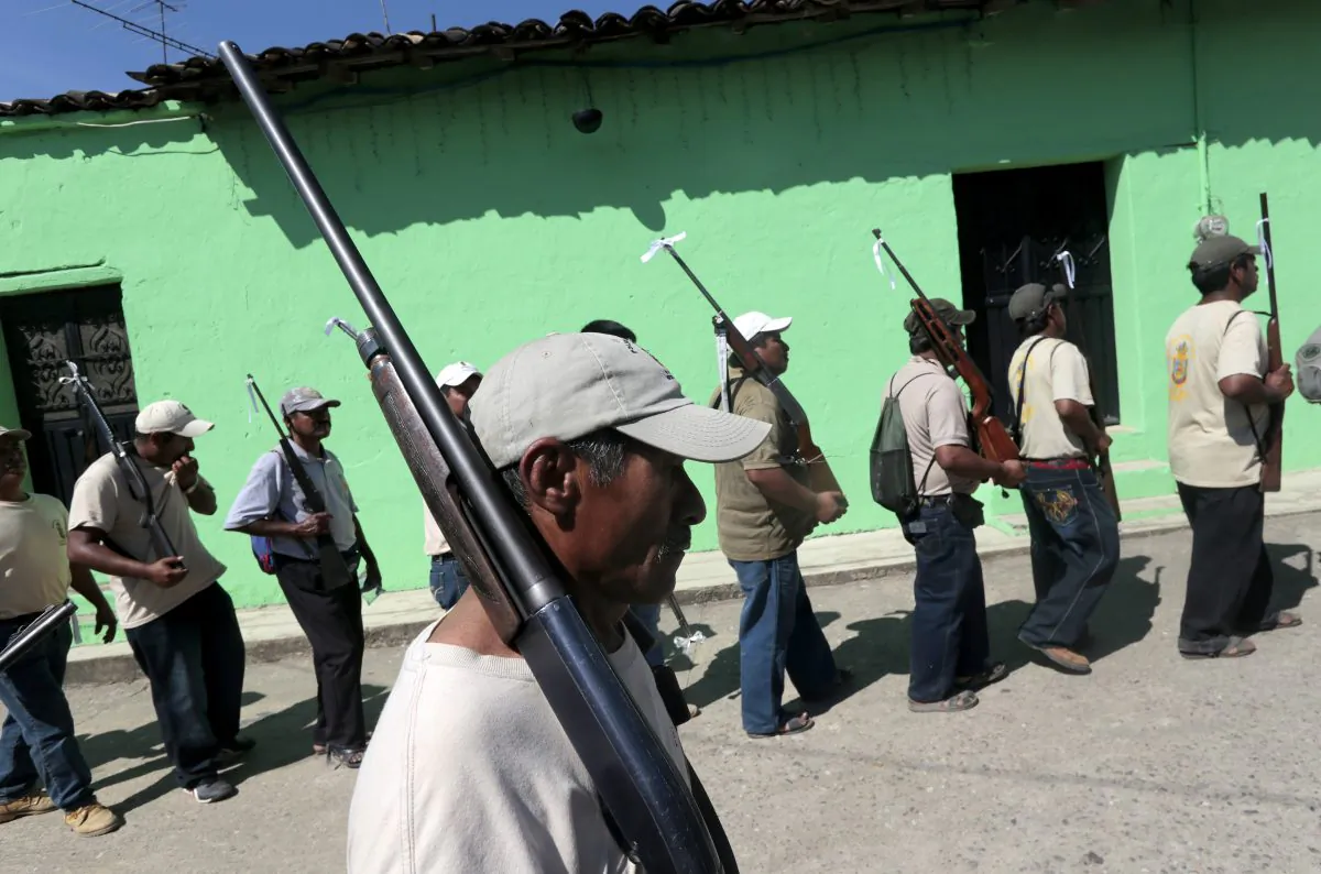 Armed residents take part in a march for the first anniversary of the citizen's vigilante groups, in Ayutla de los Libres in the southeastern state of Guerrero, Mexico, on Jan. 5, 2014. (Pedro Pardo/AFP/Getty Images)