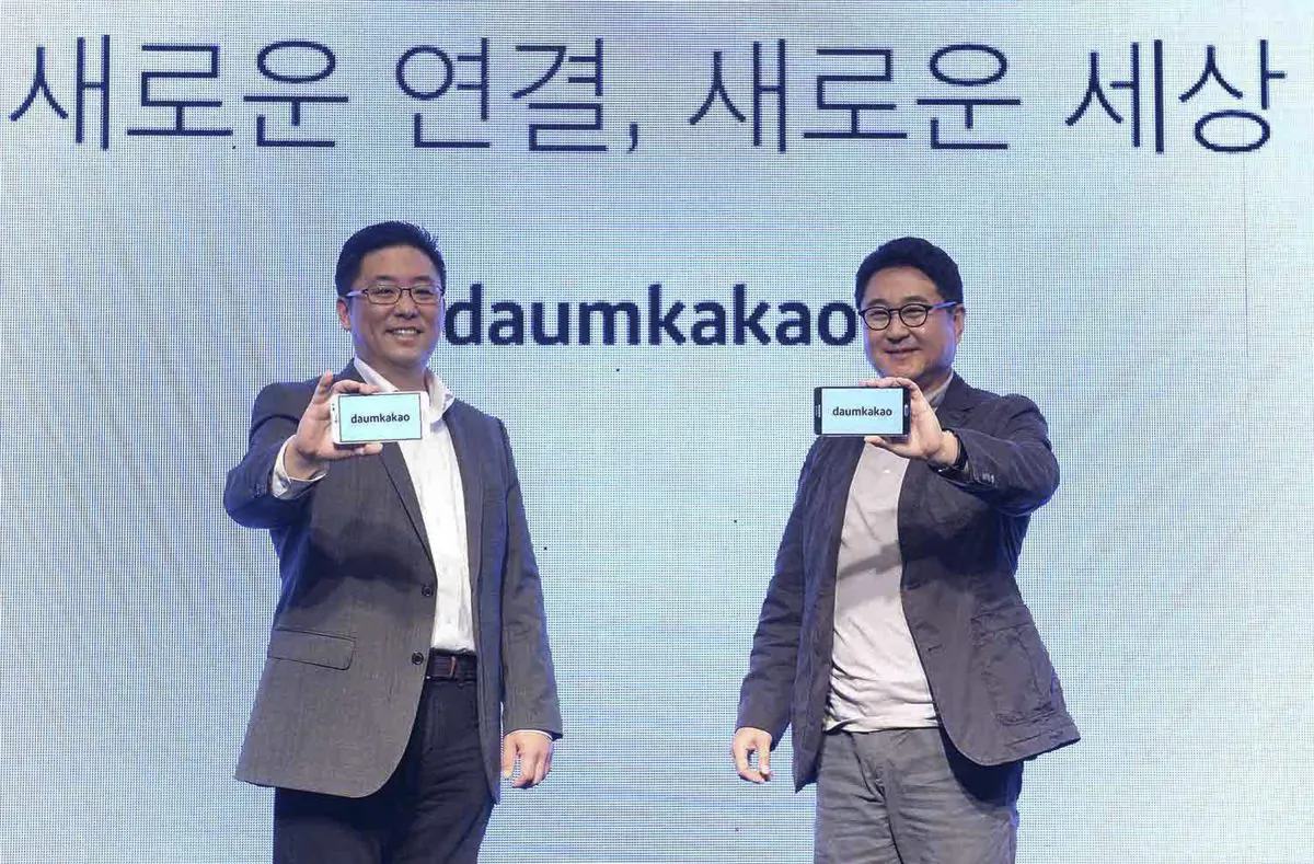 In this Oct. 1, 2014 photo released by Daum Kakao, Saehoon Choi, left, and Sirgoo Lee, the two co-CEOs of Daum Kakao, an Internet portal and app developer, show their company's new logo during a press conference in Seoul, South Korea. South Korea’s president is cracking down on rumors in cyberspace in a campaign that threatens the popularity of Daum Kakao owned Kakao Talk, the leading social media service in a country with ambitions to become a global technology leader. Prosecutors announced the crackdown two weeks ago after President Park Geun-hye complained about insults directed at her and said false rumors “divided the society.” (AP Photo/Daum Kakao)