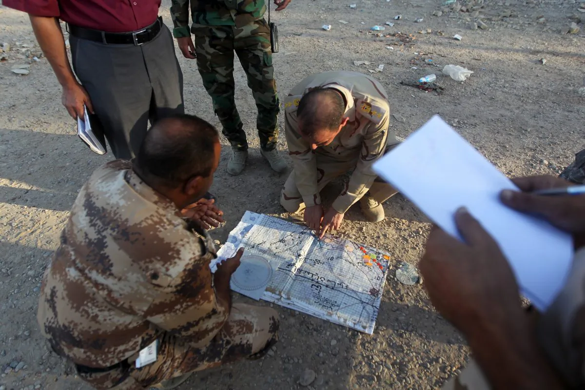 Iraqi army officers look at a map on Oct. 4, 2014, in the Sunni town of Dhuluiyah, some 45 miles north of Baghdad, where security forces, backed by Sunni gunmen fight against ISIL terrorists. (Ahmad Al-Rubaye/AFP/Getty Images)
