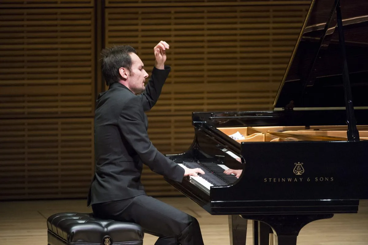 NTD Television's 2014 International Piano Competition gold winner Timur Mustakimov finishes the final note with a flourish at the Future Stars Recital at Carnegie Hall on Oct. 5, 2014. (Dai Bing/Epoch Times)