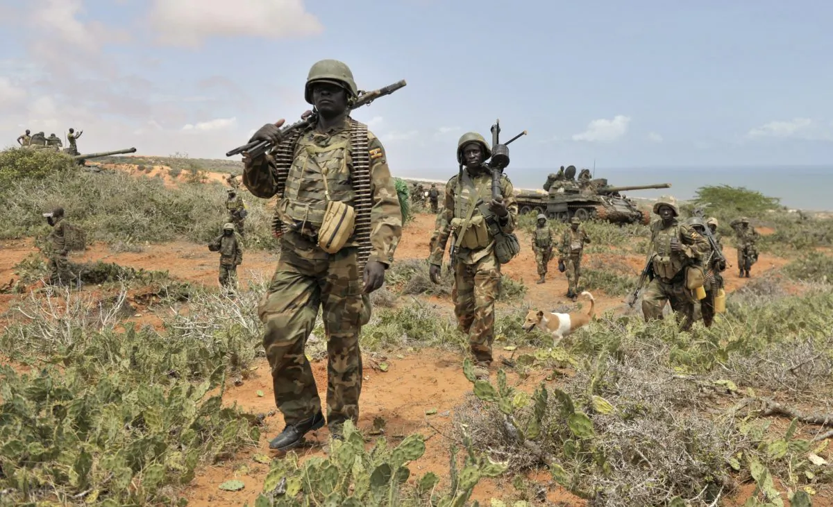 In this photo taken Sunday, Oct. 5, 2014 and provided by the African Union Mission to Somalia (AMISOM), African Union (AU) soldiers march along the top of a hill overlooking the al-Shabab stronghold of Barawe, a coastal town 220 kilometers (135 miles) southwest of Mogadishu, in Somalia. Officials in Somalia say AU and Somali troops have seized Barawe, the last major stronghold held by the Islamic militant group al-Shabab, with the AU claiming it as a significant victory because al-Shabab had used the port to bring in arms and fighters and export charcoal, a multi-million-dollar business. (AP Photo/AMISOM, Tobin Jones)