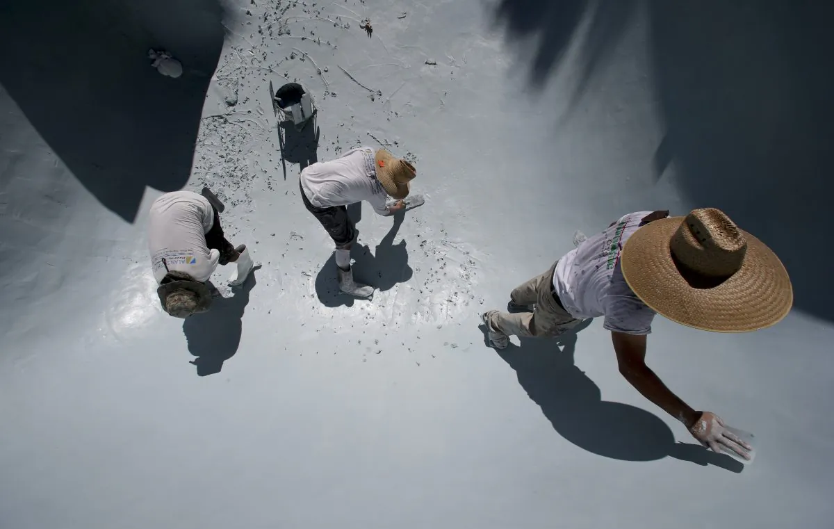 Workers replace the plaster in a swimming pool in Santa Ana, Calif. on Wednesday, Sept. 24, 2014. California swimming pool companies just regaining their financial footing after the recession are now facing a new challenge: a devastating drought that has put the state’s ubiquitous backyard pools under the microscope. (AP Photo/Chris Carlson)