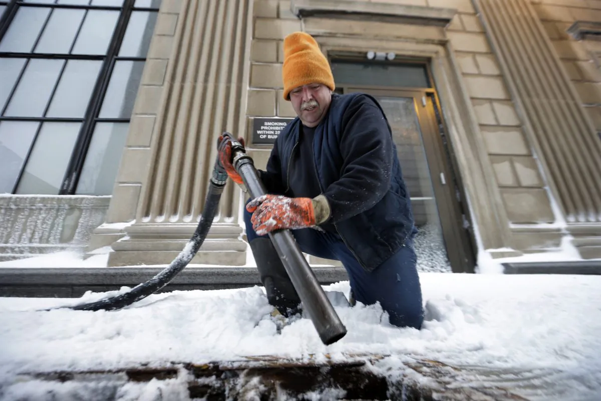 FILE - In this Feb. 13, 2014 file photo, John Wood, of Bordentown, N.J., delivers heating oil in Trenton, N.J. The Energy Department’s annual prediction of winter heating costs released Tuesday, Oct. 7, 2014 says that Americans will pay less because they won’t have to crank up the heat as much. (AP Photo/Mel Evans, File)