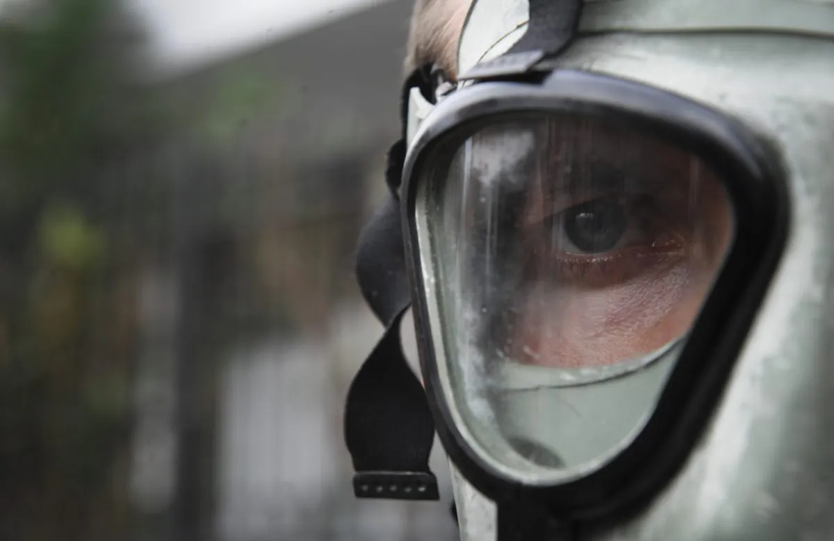 A man wearing a gas mask takes part in a protest against the prospect of using Albania as a site for destroying Syria's chemical weapons stockpile in front of Albanian Embassy in Pristina on Nov. 12, 2013. (Armend Nimani/AFP/Getty Images)
