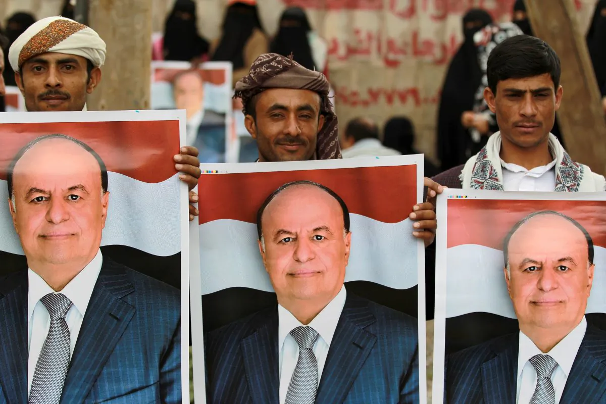 Demonstrators hold up posters bearing the portrait of Yemen's President Abd-Rabbu Mansour Hadi during a pro-government demonstration on Aug. 26, 2014, in the Yemeni capital Sanaa. Rival protests stoked up tension in Yemeni capital Sanaa on Aug. 24, as a presidential negotiating team abandoned talks with Shiite rebels, accusing them of seeking to ignite a war. (Mohamed Huwais/AFP/Getty Images)