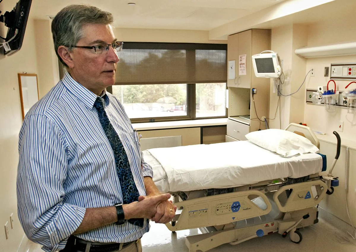 FILE - In this photo taken on Monday, Sept. 29, 2014, file photo, Dr. George Risi, an infectious disease specialist, shows one of St. Patrick Hospital’s three rooms in Missoula, Mont., that are equipped to handle infectious diseases like Ebola. St. Patrick's has had the isolation wing of its intensive care unit since 2007, and is one of a handful of facilities in the United States set up to care for patients with Ebola. (AP Photo/The Missoulian, Tom Bauer)