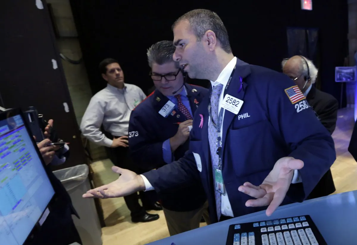 Specialist Philip Fianle (R) directs trades in Rite Aid on the floor of the New York Stock Exchange on Sept. 18, 2014. The securities industry in New York City tallied $8.7 billion in profits during the first half of 2014, which was 13 percent lower than the same period last year, New York's comptroller reported Tuesday. (AP Photo/Richard Drew)