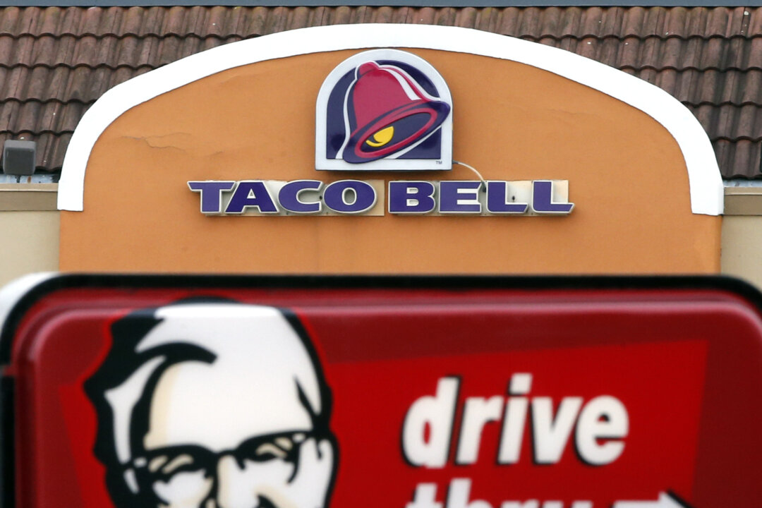 A Taco Bell facade behind a KFC drive-thru sign in Saugus, Mass., on Jan. 31, 2014. (Elise Amendola/File Photo via AP)