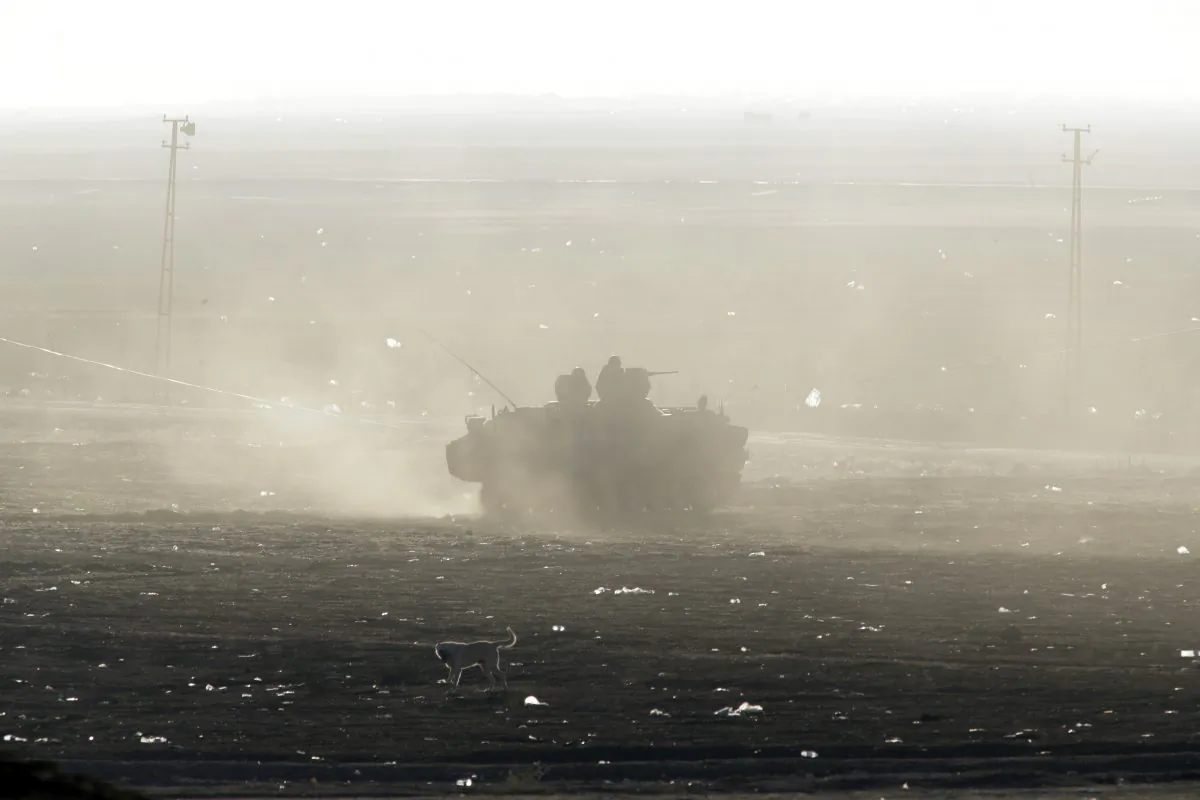 A Turkish forces armored vehicle patrols the border road in Mursitpinar, on the outskirts of Suruc, as fighting in nearby Kobani, Syria intensified between Syrian Kurds and militants of Islamic State group, at the Turkey-Syria border, Tuesday, Oct. 7, 2014. Kobani, also known as Ayn Arab and its surrounding areas have been under attack since mid-September, with militants capturing dozens of nearby Kurdish villages.(AP Photo/Lefteris Pitarakis)