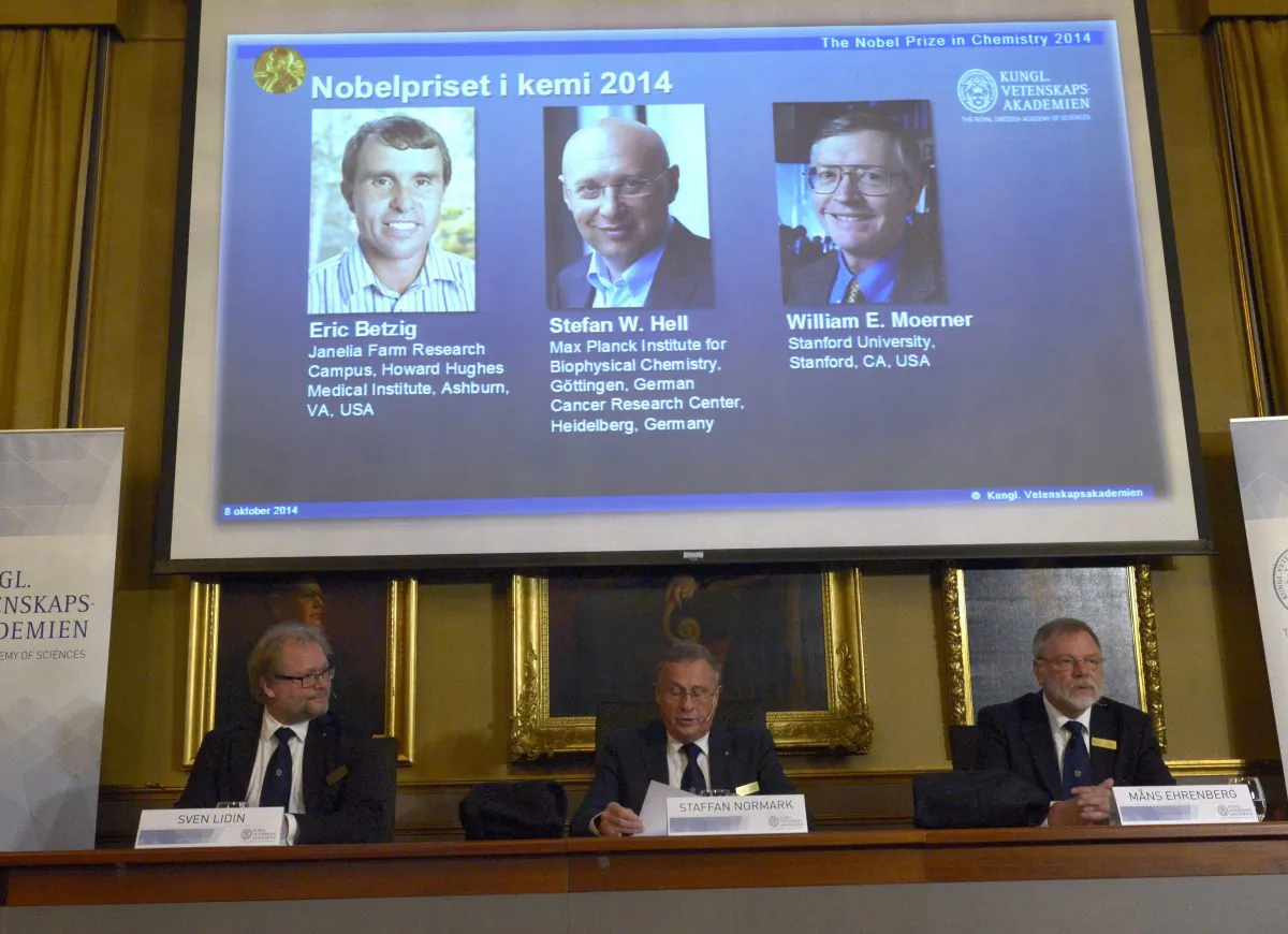 Sven Lidin, left , Staffan Nordmark, centre, and Mans Ehrenberg at the Royal Academy of Sciences Wednesday Oct. 8, 2014 announce the Nobel Chemistry laureates 2014. Americans Eric Betzig and William Moerner and German scientist Stefan Hell won the Nobel Prize in Chemistry for "the development of super-resolved fluorescence microscopy." The Royal Swedish Academy of Sciences says the work of the three scientists "has brought optical microscopy into the nanodimension." (AP Photo/Bertil Ericson) SWEDEN