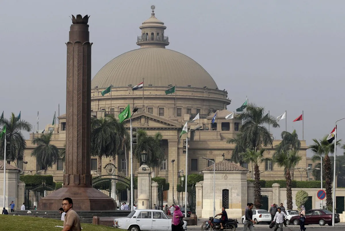 Egyptians walk outside Cairo University, popular with its 100-year-old dome in Cairo, Egypt, Wednesday, Oct. 8, 2014. Summer vacation ends this weekend, and universities across Egypt are preparing for the return of students with a heavy, pre-emptive clampdown. The aim is to prevent a resurgence of protests by supporters of Mohammed Morsi, the Islamist president who was removed by the military just over a year ago. (AP Photo/Hassan Ammar)
