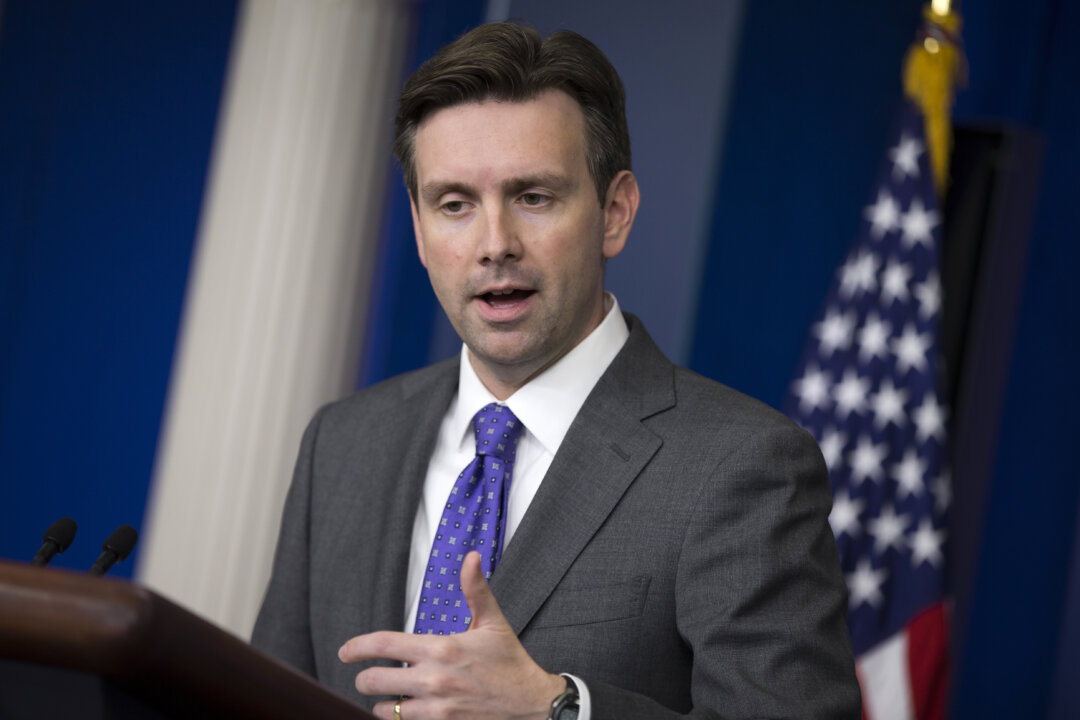 White House press secretary Josh Earnest gestures as he answers a question during the daily press briefing at the White House in Washington, Wednesday, Oct. 8, 2014. Earnest talked about temperature screenings at five airports for passengers arriving from West Africa to fight the Ebola outbreak. (AP Photo/Evan Vucci)