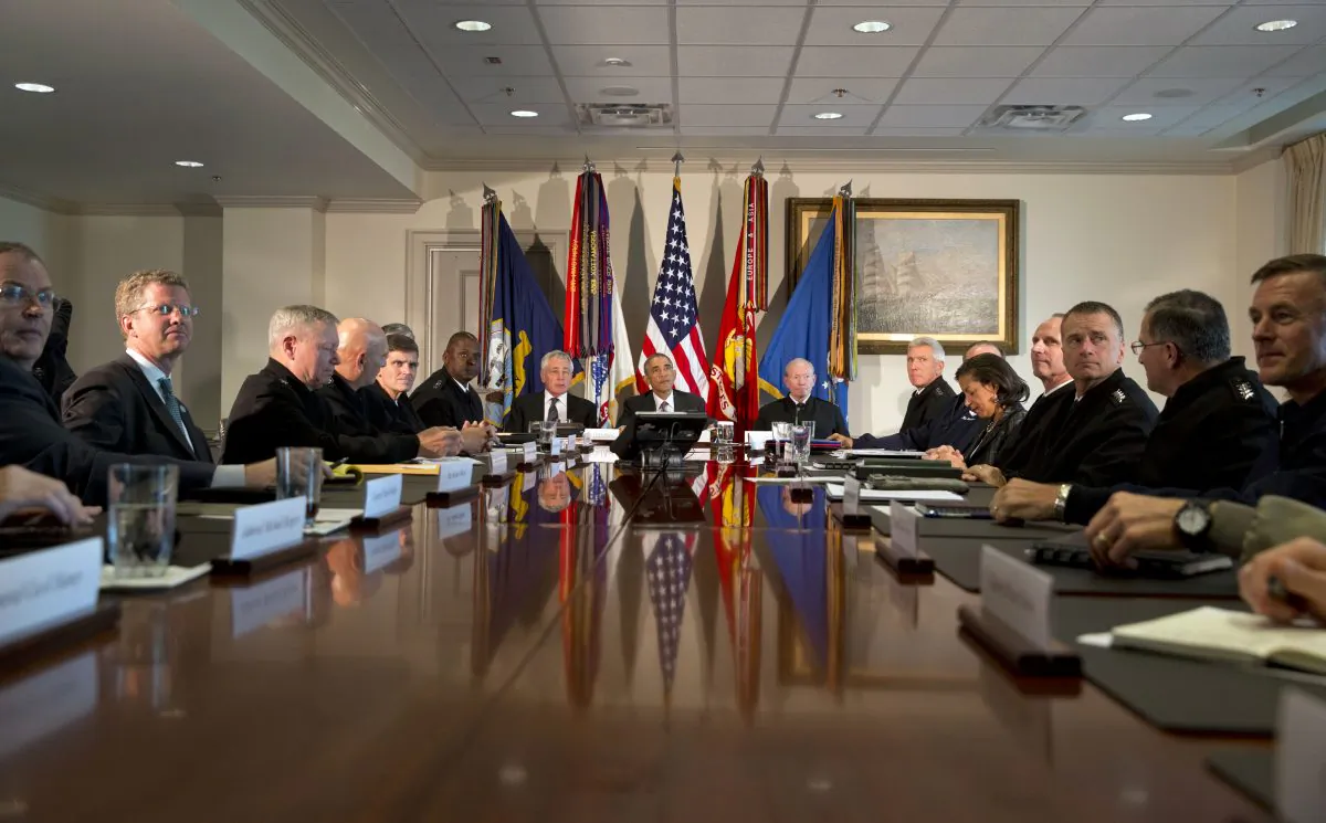 President Barack Obama (C) speaks to the media at the conclusion of a meeting with senior military leadership including Secretary of Defense Chuck Hagel (L) and Chairman of the Joint Chiefs of Staff Gen. Martin Dempsey (R) at the Pentagon on Wednesday, Oct. 8, 2014. (AP Photo/Jacquelyn Martin)
