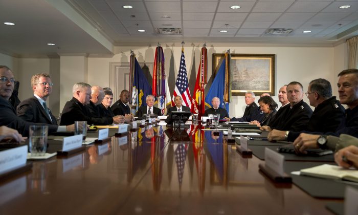 President Barack Obama (C) speaks to the media at the conclusion of a meeting with senior military leadership including Secretary of Defense Chuck Hagel (L) and Chairman of the Joint Chiefs of Staff Gen. Martin Dempsey (R) at the Pentagon on Wednesday, Oct. 8, 2014. (AP Photo/Jacquelyn Martin)