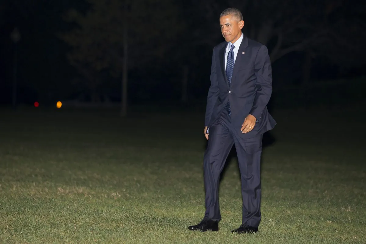 President Barack Obama walks across the South Lawn of the White House on return from a fundraising trip to New York City and Connecticut, Tuesday, Oct. 7, 2014, in Washington. (AP Photo/Jacquelyn Martin)