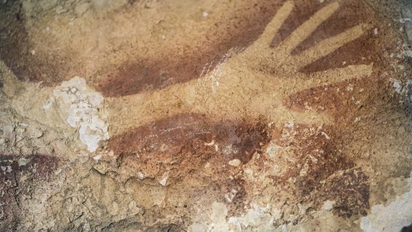 Stencils of hands in a cave in Indonesia. Ancient cave drawings in Indonesia are as old as famous prehistoric art in Europe, according to a new study that shows our ancestors were drawing all over the world 40,000 years ago. And it hints at an even earlier dawn of creativity in modern humans than scientists had thought. (AP Photo/Kinez Riza, Nature Magazine)