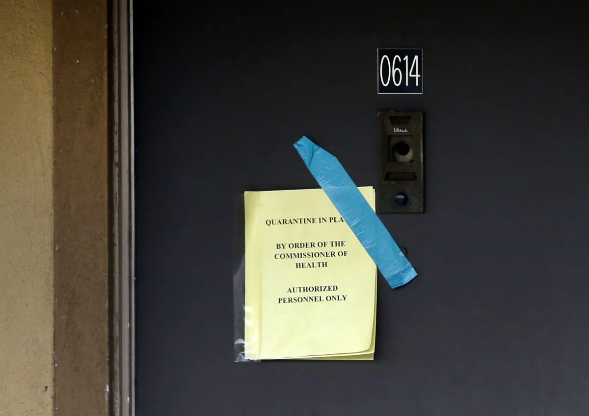 A sign on the door of the apartment where Thomas Eric Duncan stayed with family warns that the unit has been quarantined by the commissioner of health, Wednesday, Oct. 8, 2014, in Dallas. Texas Health Presbyterian Hospital Dallas, where Duncan was being treated for Ebola, said that Duncan has died. The apartment was stripped bare, including the blinds that used to hang in the winds. (AP Photo/Tony Gutierrez)