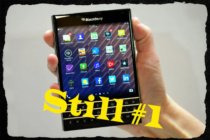 A woman holds the Blackberry Passport smartphone during at a simultaneous launch event in London on Sept. 24, 2014. BlackBerry on Wednesday unveiled its newest smartphone with a full physical keyboard and a large screen, aiming to return to its roots targeting business users. (Carl Court/AFP/Getty Images; effects added by Epoch Times)