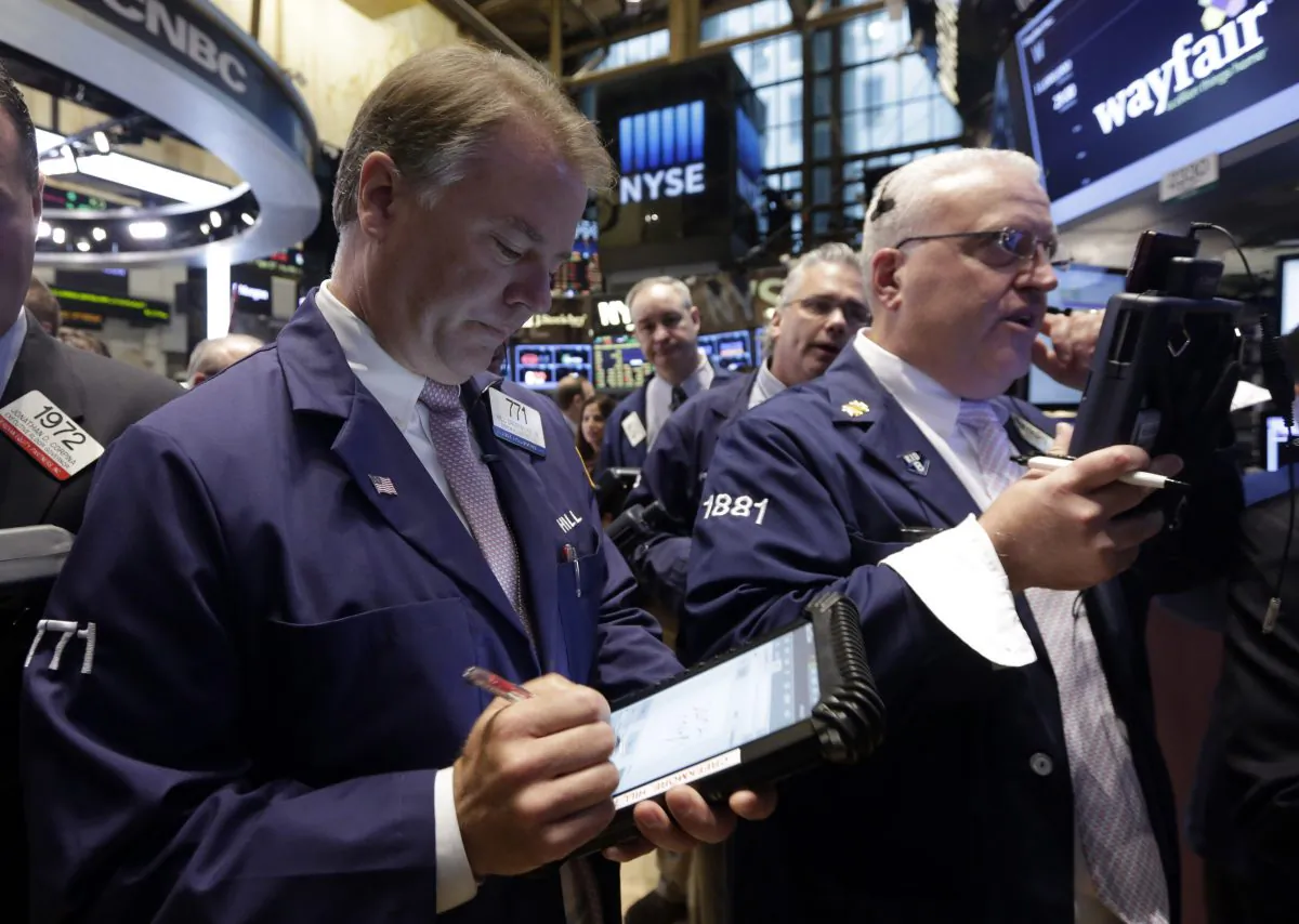 Traders F. Hill Creekmore and Thomas Ferrigno (R) work on the floor of the New York Stock Exchange, Thursday, Oct. 2, 2014. US stocks were solidly lower in early trading Thursday, Oct. 9, 2014, pruning back some of the gains from a massive rally the day before. Gap shares plunged after the company announced its CEO was retiring. (AP Photo/Richard Drew)