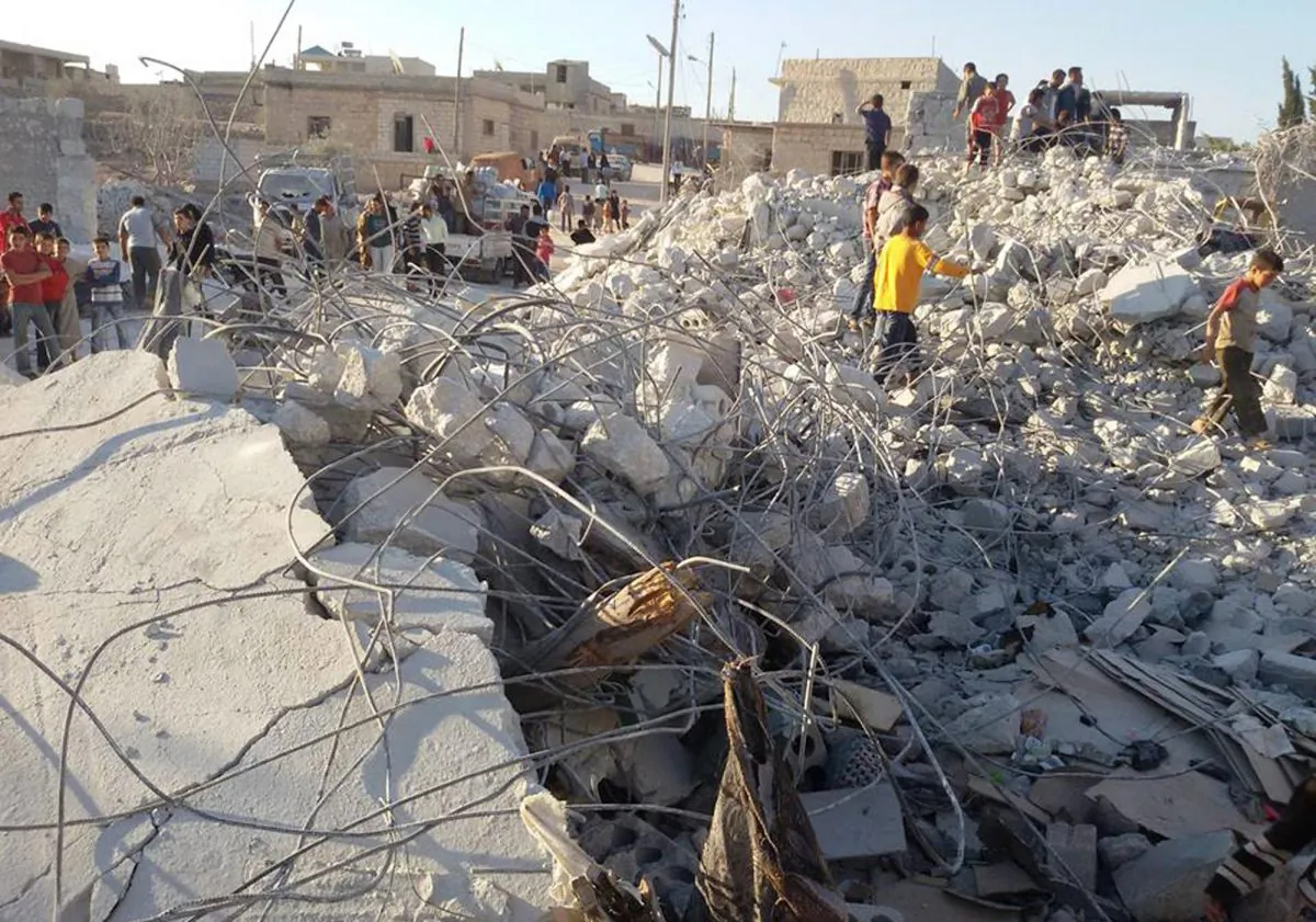Syrian citizens check a damaged house that they say was targeted by the coalition airstrikes, in the village of Kfar Derian, a base for the al-Qaeda-linked Nusra Front, a rival of the Islamic State group, between the northern province of Aleppo and Idlib, Syria, on Sept. 23, 2014. The barrage of US cruise missiles last month aimed at a terror cell in Syria killed just one or two of the key militants, according to American intelligence officials who say the al-Qaeda group is still believed to be plotting attacks against targets in the United States and Europe. (AP Photo/Edlib News Network ENN)