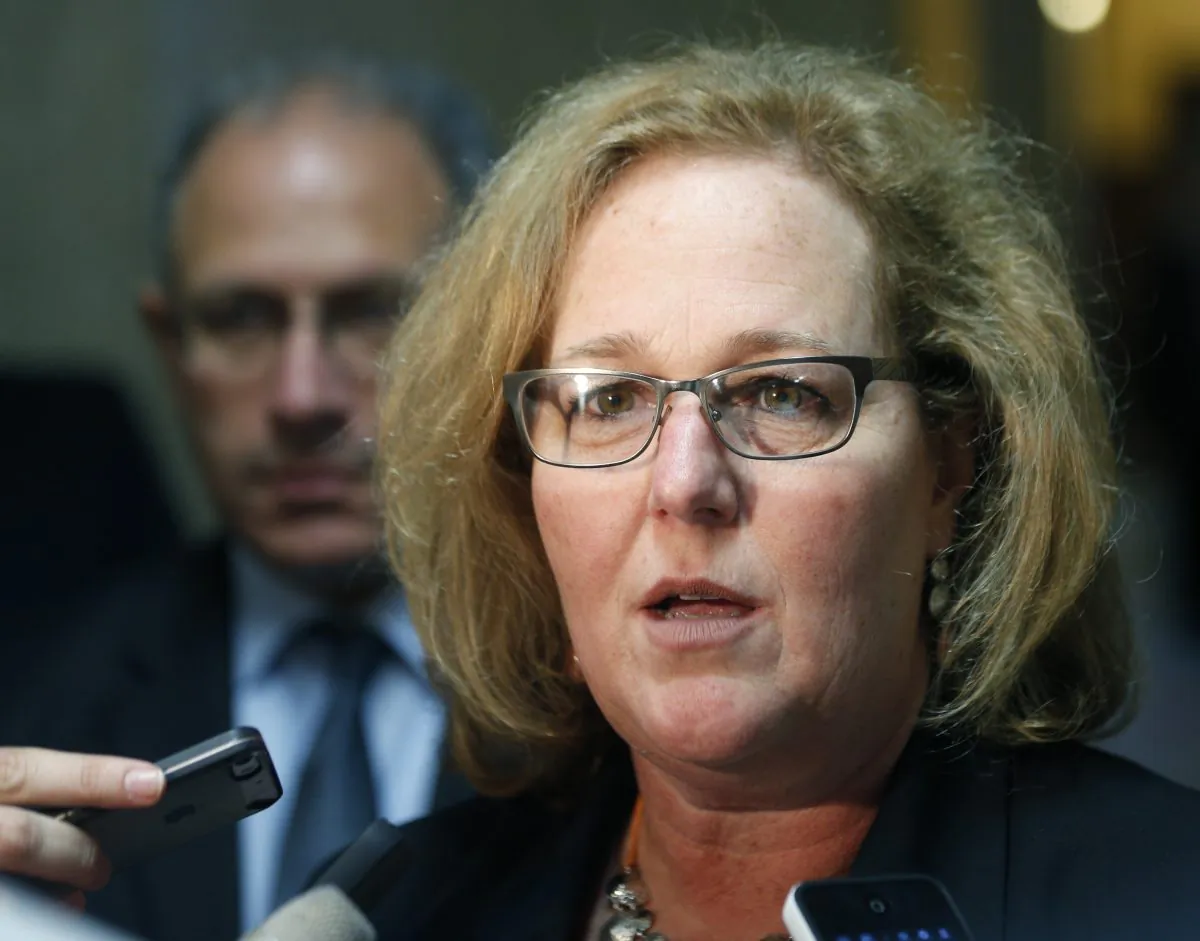 New York State United Teachers President Karen Magee talks with reporters in a hallway at the Capitol in Albany, N.Y., on June 19, 2014. New York's largest teachers union is suing the state Education Department over what it views as a "gag order" on teachers who score state tests. (AP Photo/Mike Groll)