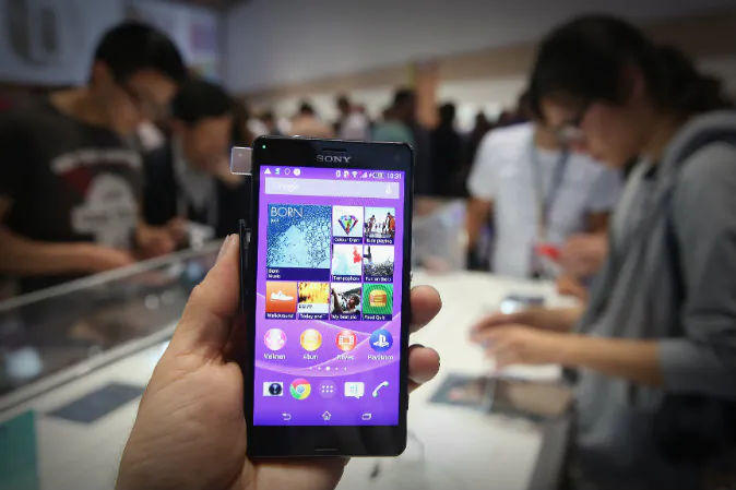 The photographer holds up a Sony Xperia Z3 smartphone at the Sony stand at the 2014 IFA home electronics and appliances trade fair in Berlin, Germany on Sept. 5, 2014 .(Sean Gallup/Getty Images)