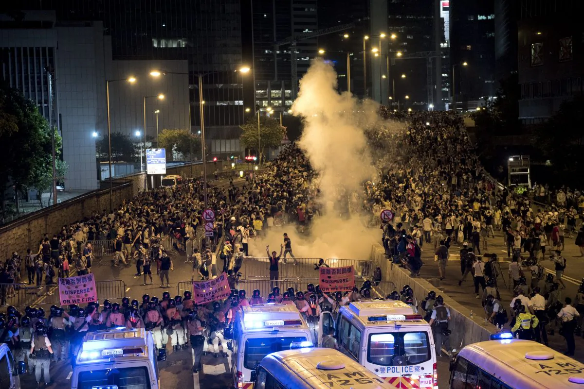 Police fire tear gas at pro-democracy protesters in Hong Kong on Sept. 28, 2014. On Sept. 29, Voice of America put into effect a previously scheduled cut in TV broadcasts to Hong Kong and China, broadcasts that were replaced by Radio Free Asia programming. (Alex Ogle/AFP/Getty Images)