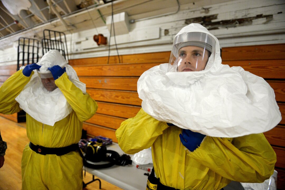 Members of the Army's 101st Airborne Division conduct a training exercise at Ft. Campbell, Ky., Thursday, Oct. 9, 2014. Members will travel to Liberia to build treatment centers and conduct medical training as part of the fight against the Ebola epidemic.  (AP Photo/The Courier-Journal, Stephen Lance Dennee) 