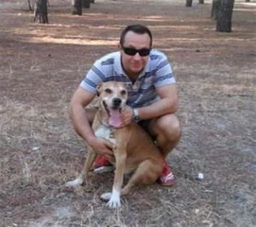 This is an undated image released on Wednesday Oct. 8, 2014 by animal rights organisation PACMA of Javier Limon, husband of the nurse assistance who is infected with Ebola in Madrid, with his dog named Excalibur. At least one major study suggests that dogs can be infected with the deadly virus without having symptoms. But whether or how likely they are to spread it to people is less clear. (AP Photo. PACMA)