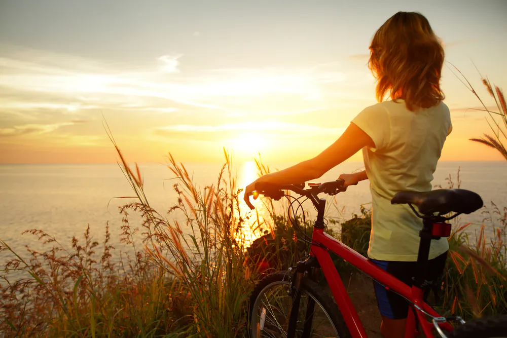 A woman watching the sun set (Shutterstock*)