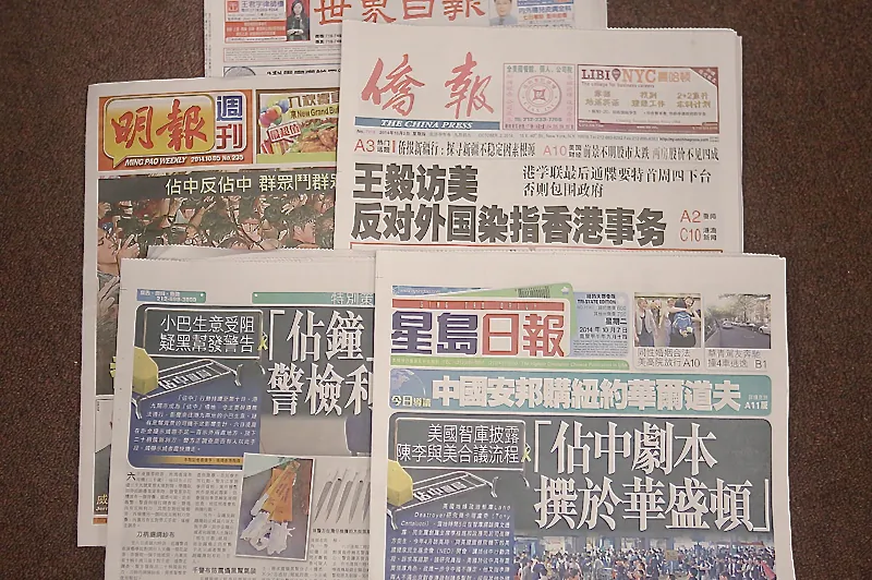 Several Hong Kong newspapers with reports on Hong Kong’s pro-democracy movement Occupy Central. The tone of a number of Hong Kong media outlets in reporting on Occupy Central has aligned with that of the Chinese Communist Party media outlets in mainland China. (Epoch Times)