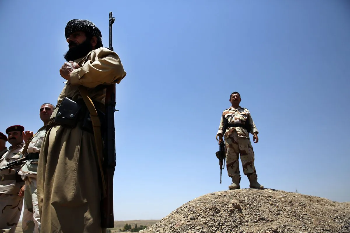 Soldiers with the Kurdish peshmerga walk at an outpost on the edges of the contested city of Kirkuk on July 3, 2014 in Kirkuk, Iraq. (Spencer Platt/Getty Images)