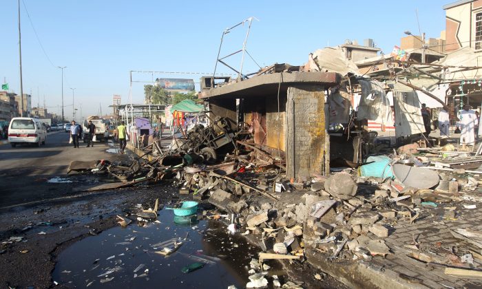 A picture shows the site of an explosion in the aftermath of a car bomb attack in the mostly Shiite Sadr City district of Baghdad on Oct. 9, 2014. (Ahmad al-Rubaye/AFP/Getty Images)