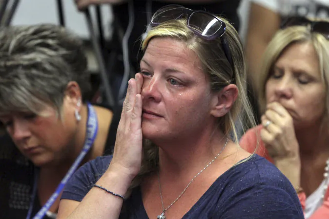 In this Friday, Oct. 3, 2014 photograph, audience members react as members of the Sayreville Board of Education hold a news conference at the Selover School in South Amboy, N.J., to address a hazing incident that "went too far" and is at the center of the investigation into the Sayreville War Memorial High School football team. On Monday, Oct. 6, 2014, school superintendent Richard Labbe said the Sayreville War Memorial High School football season has been canceled amid allegations of harassment, intimidation and bullying among players. (AP Photo/ Home News Tribune, Mark R. Sullivan) On Friday October 3,,2014 Photo: Mark R. Sullivan/Home News Tribune/AP