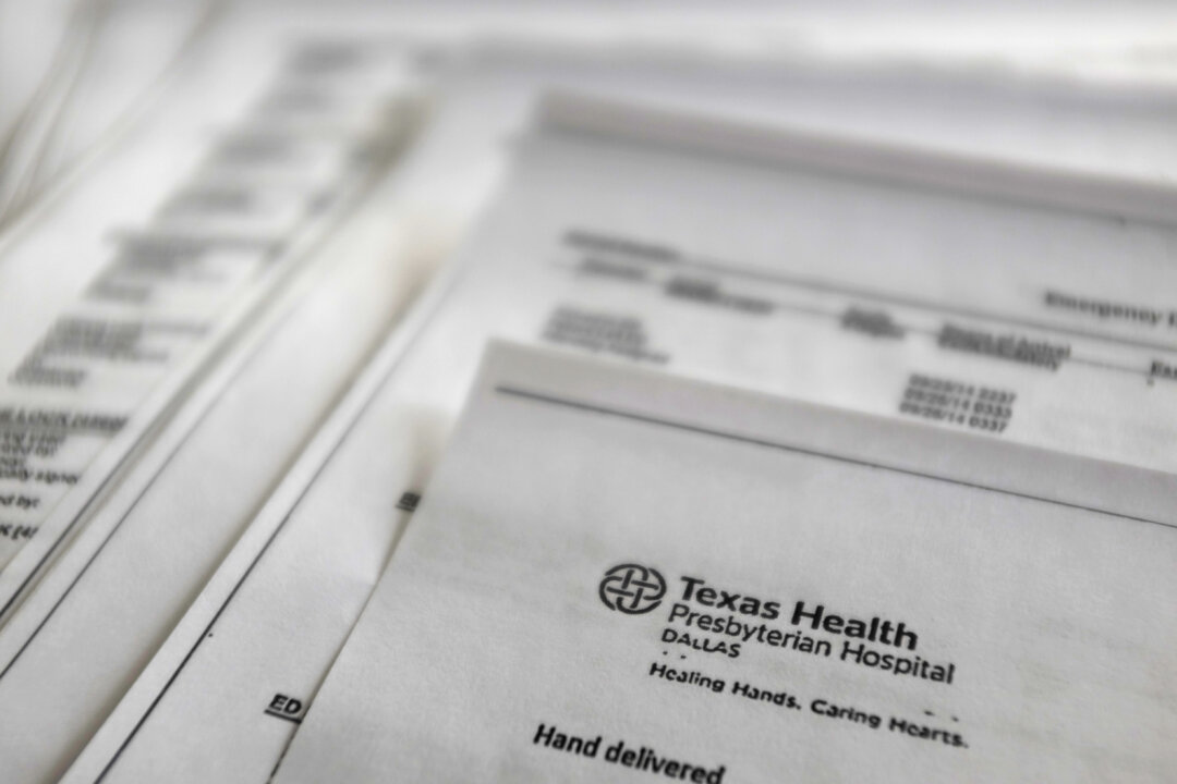 A copy of Thomas Eric Duncan's medical records from Texas Health Presbyterian Hospital, provided by Duncans family to The Associated Press, on Oct. 10, 2014. The records encompass his time in the emergency room, his urgent return to the hospital two days later and a chronicle of his steep decline as his organs began to fail. Duncan carried the deadly Ebola virus with him from his home in Liberia, though he showed no symptoms when he left for the United States. He arrived in Dallas on Sept. 20 and fell ill several days later. (AP Photo/Kiichiro Sato)