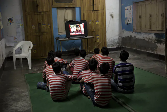 Children rescued by the workers of the NGO Bachpan Bachao Andolan or Save Childhood Movement, run by Kailash Satyarthi, watch the news of Pakistan’s Malala Yousafzai on television at the Mukti Ashram in New Delhi, India, Friday, Oct. 10, 2014. Satyarthi and Malala jointly won the Nobel Peace Prize on Friday for working to protect children from slavery, extremism and child labor at great risk to their own lives. (AP Photo/Bernat Armangue)